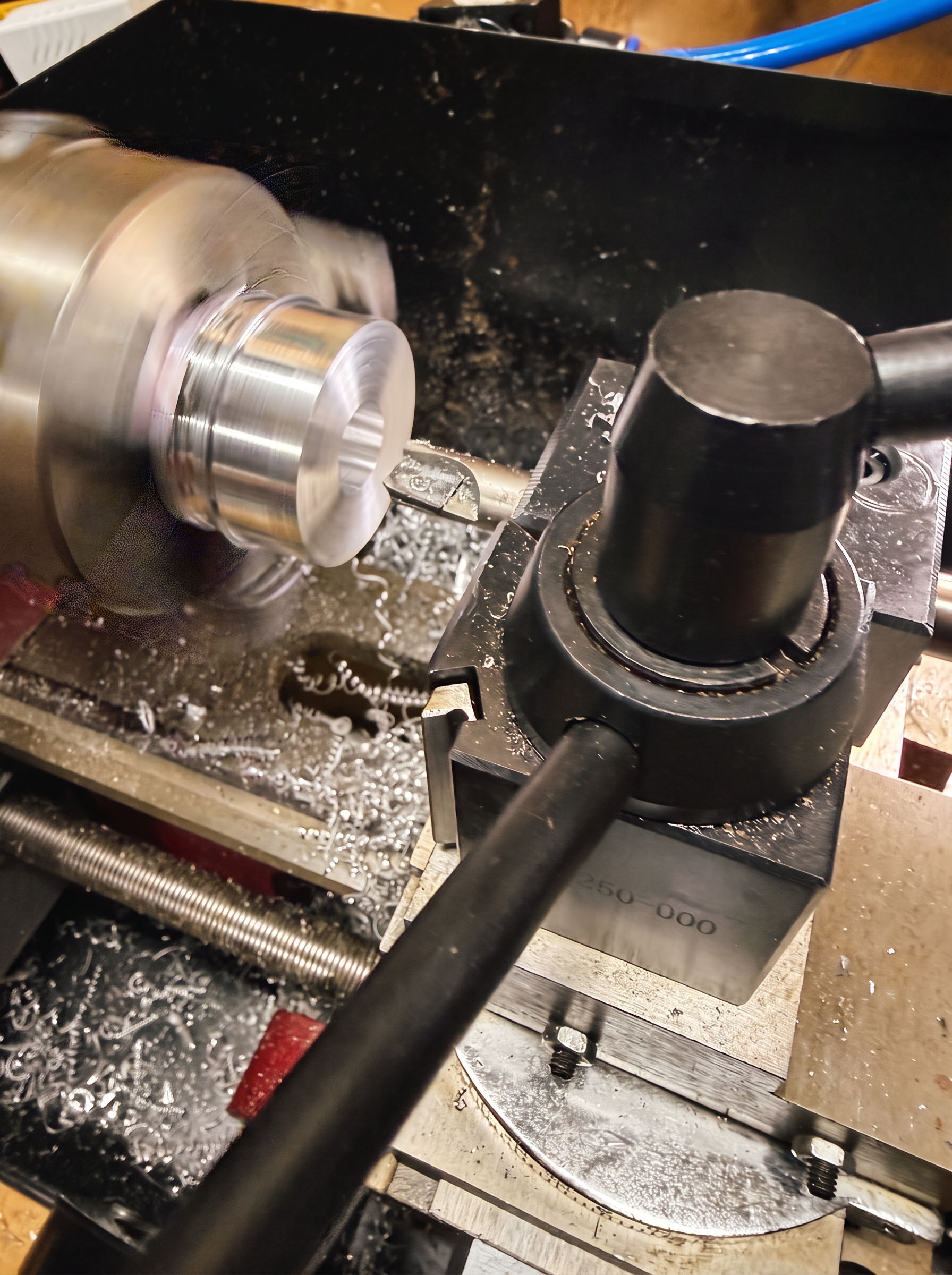 A case component turning on the lathe, cut to dimension by hand